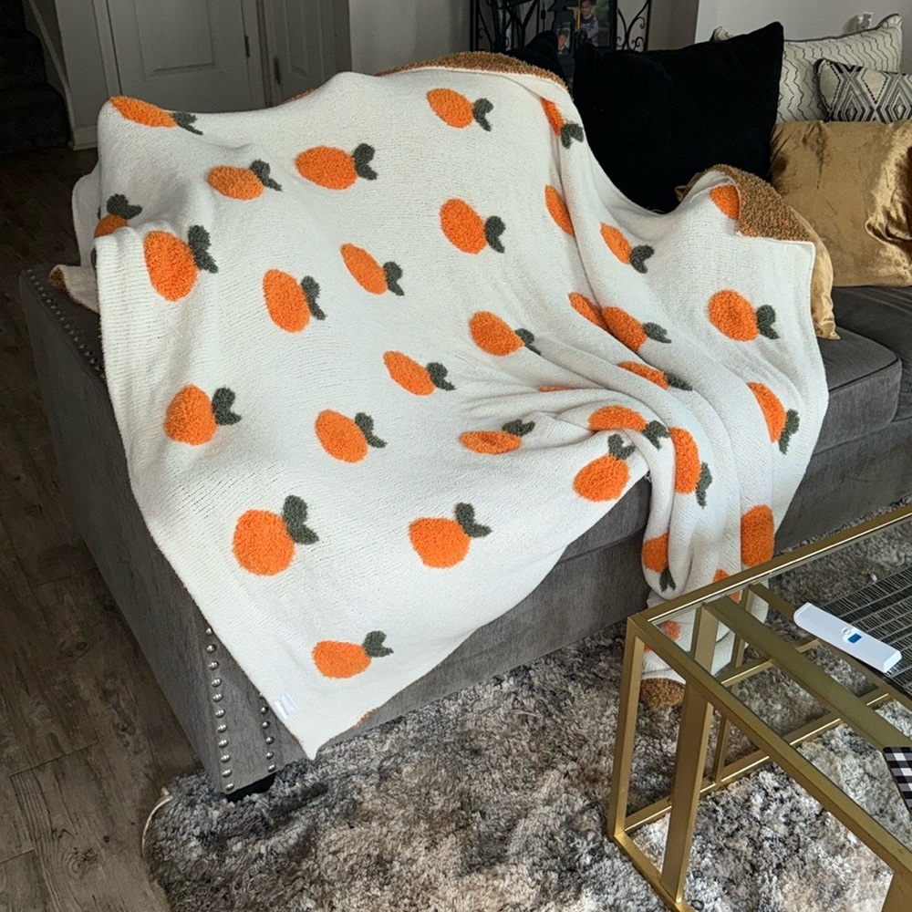 Cozy White Blanket with Orange and Green Accents